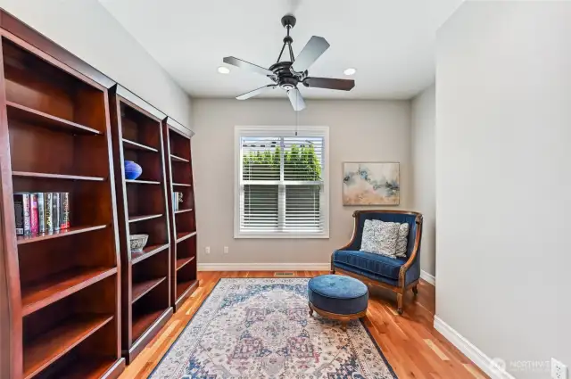 Nice sized den/office also with cherry hardwood floors and a ceiling fan. Nice greenery out the window.