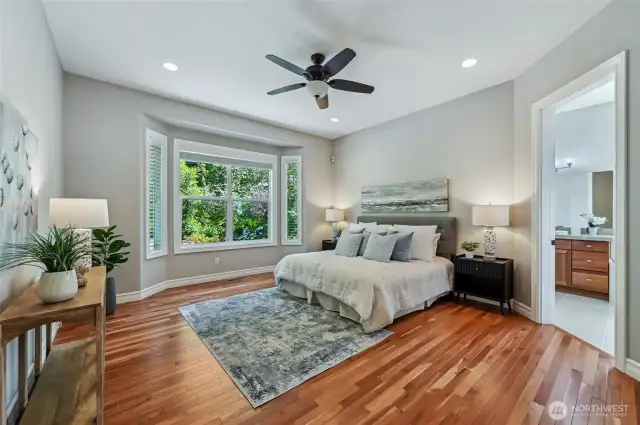 The primary suite easily accommodates a king size bed and it overlooks the extremely private backyard.