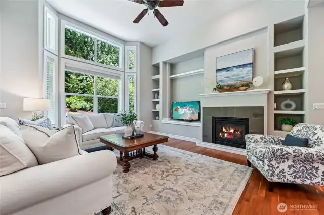 The gas fireplace is flanked with display shelves and there is room for a full size TV! The gas fireplace has a mantle and contemporary surround.