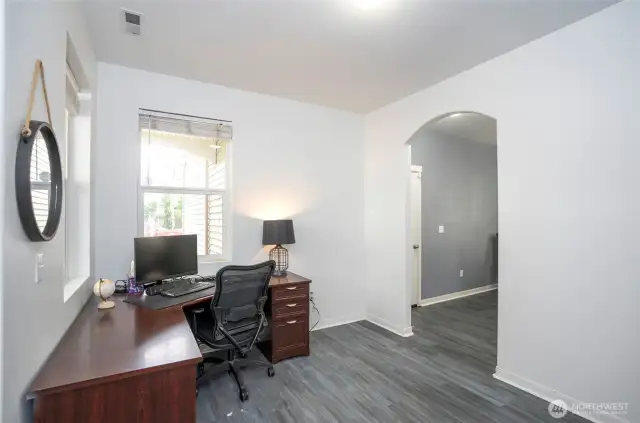 Another view of the flexible multi-purpose room, with the dining room showcased through the elegant archway.