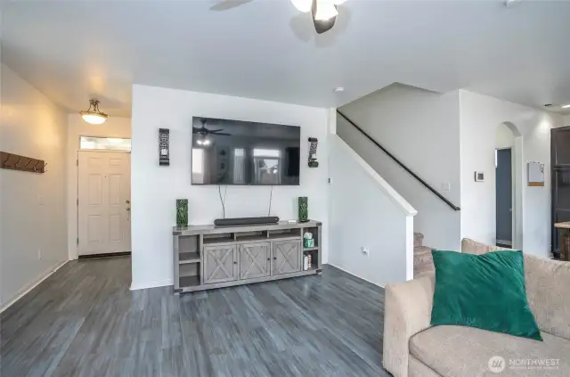 Open family room enhanced by stylish laminate flooring.
