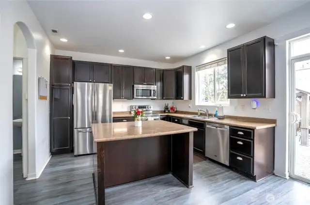 The island kitchen offers generous counter space for meal prep and casual seating—perfect for quick bites or gathering with family and friends.