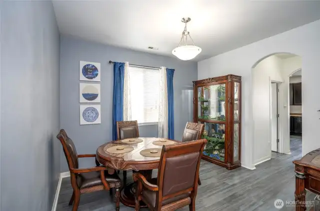 Spacious dining area perfect for entertaining guests, with a convenient hallway to the right leading directly to the kitchen.
