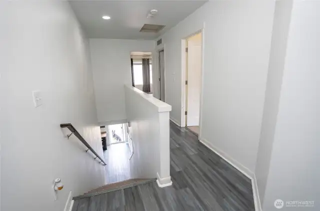 Spacious upper-level landing leads to the primary suite, three guest bedrooms, and a conveniently located laundry room for added ease.