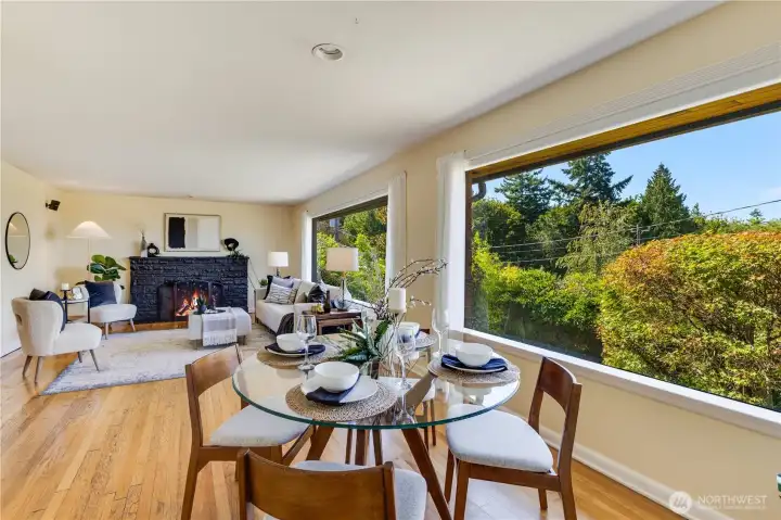 Huge picture windows draw in natural light and views of nature, making the room feel even more spacious and inviting.