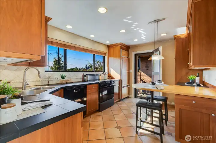 A convenient feature of this kitchen is the side door with outside access. This view shows the door open.