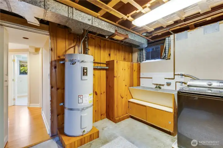 Finish this space to your liking, or use just as it is. The classic utility sink, wood paneling, and storage cubbies show off original mid-century features.