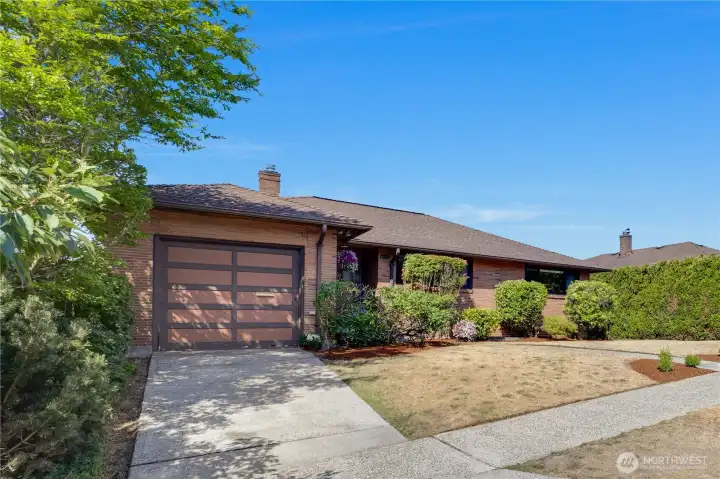 The home features driveway parking and an attached one-car garage with interior access into the home.