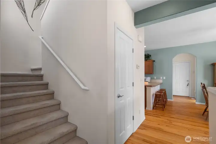 Foyer/entrance with ceramic tile that leads to hardwood floors.