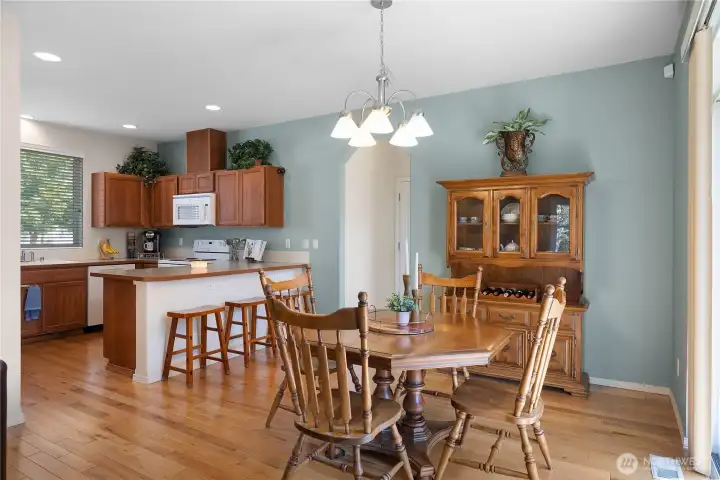 Dining room with hardwood floors and sliding glass door to backyard.
