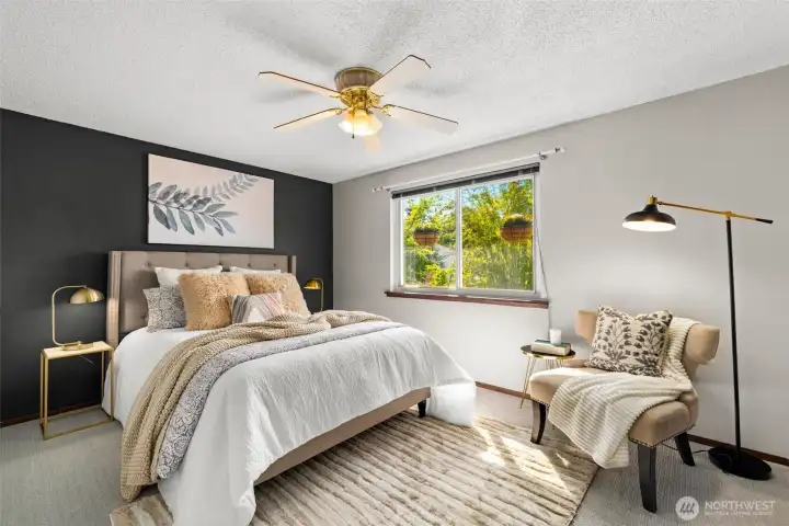 Bright primary bedroom with fresh paint and new carpet