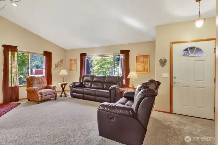Vaulted ceilings in living room and a lot of light.