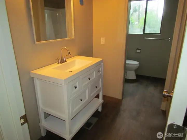 This bathroom is located on the main floor and it has two doors one that goes to the Primary and the other is for your guests.