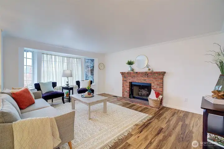 Just at the top of the stairs is the living room with a cozy wood burning fireplace.