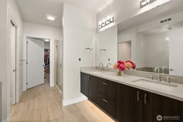 Heated floors offer cozy warmth. The under-cabinet lighting and dual sinks are a luxury you would expect in a home like this.