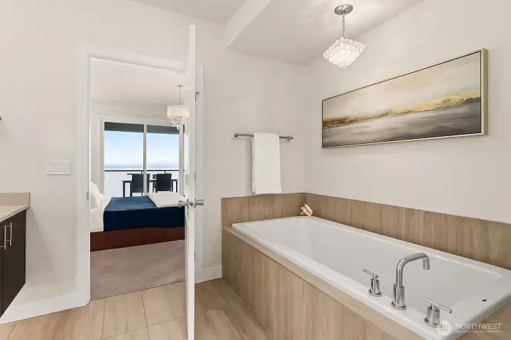 Soak your cares away in the deep and comforting tub. *Virtually staged*