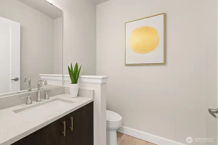 Guest bath by entry door. Perfect for when you are entertaining guests.  *Virtually staged*