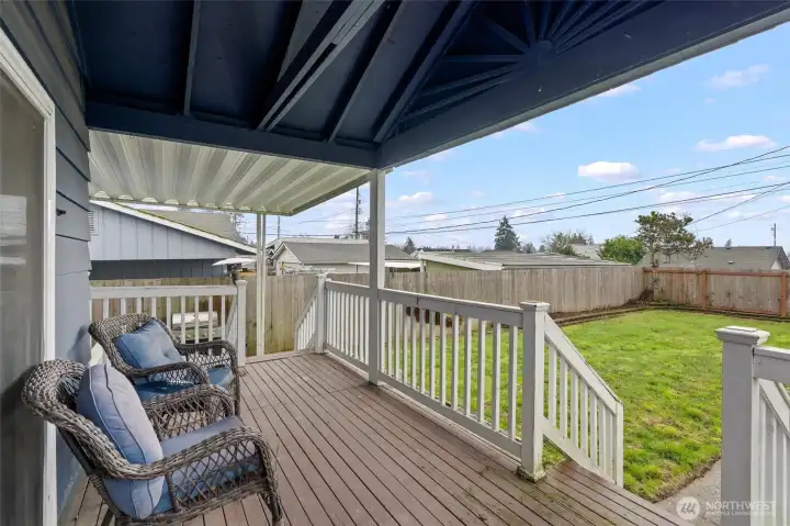 Large covered deck - furniture conveys.