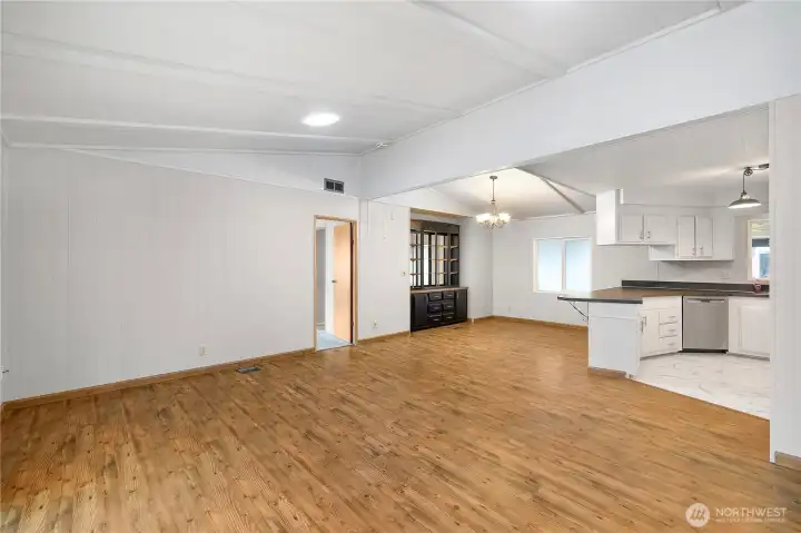 An unobstructed view of your over-sized living space fully integrated with dining and kitchen. Notice the newer skylight tunnels above, newer flooring, and paint. Great entertaining space!
