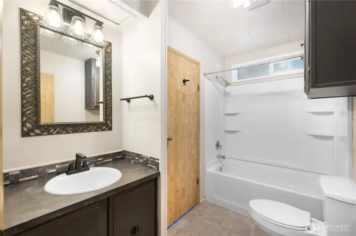 Guest bathroom is conveniently located to living spaces and additional bedrooms. Home has great flow. Notice updated fixtures and lighting!