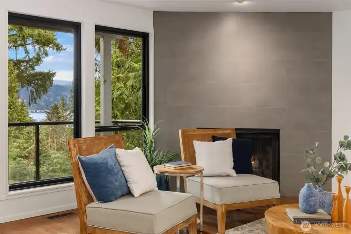 Cozy living area with fireplace and Lake Washington views through expansive windows