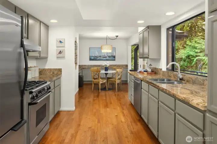 Charming breakfast nook just off the kitchen, surrounded by windows and perfect for casual dining