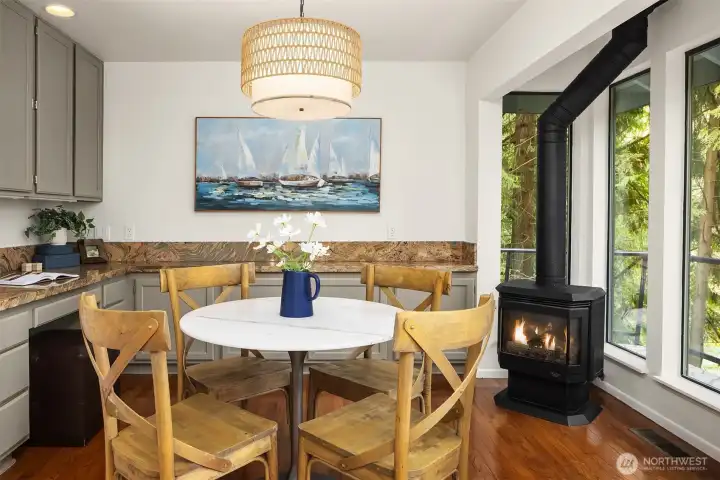 Charming breakfast nook with built-in cabinetry and cozy gas stove, perfect for casual dining