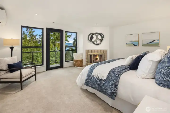 Entire upper level dedicated to the primary suite with fireplace, balcony access, walk-in closet, and newly renovated spa bath.