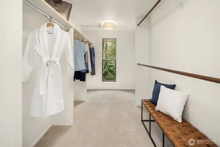 Well-appointed walk-in closet with extensive hanging space and natural light