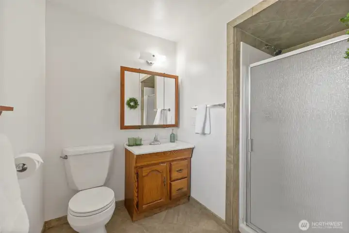 Good sized bathroom with full tiled walk in shower