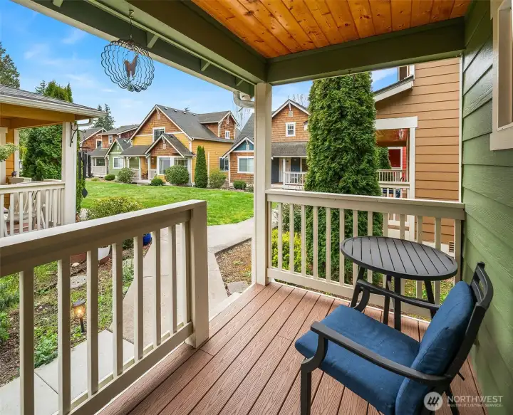 The covered front porch, with wood soffits and railings, invites morning coffee in comfortable elegance.