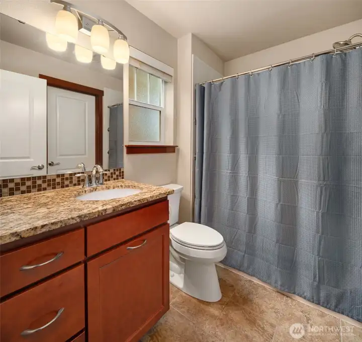Wood cabinets, lovely countertops, and stylish tile accents in the primary 3/4 bath. You can fit at least 7 of your friends in the large walk in closet of the primary bedroom.