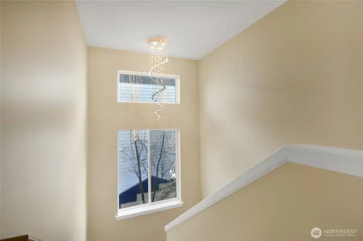 Statement chandelier illuminating the stairway