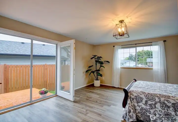 Primary bedroom with the French doors open to the deck