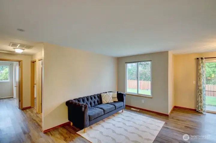 Another view of living room and hallway towards the 2 bedrooms