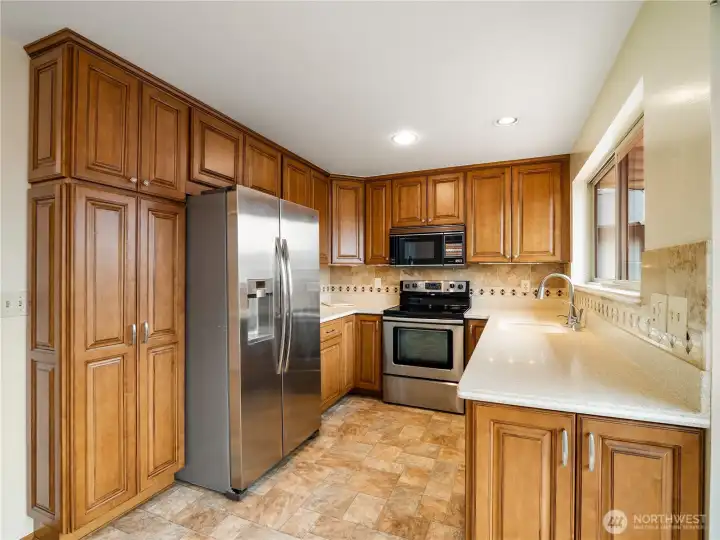 The kitchen has been updated and features stainless steel appliances and ample storage options.