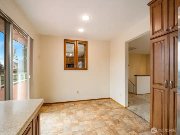 The dinette area is adjacent to the kitchen making it an efficient dining location. The large slider offers breath taking views.