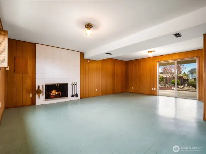 The lower level features a huge recreation room with an attractive gas fireplace. The room opens to the spacious covered patio through a big sliding door.