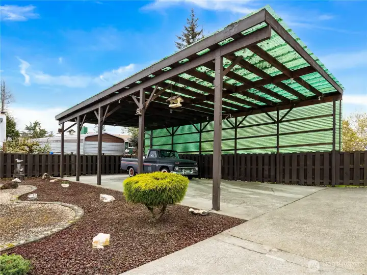 One of this home's biggest assets is this hard to find carport with ample space for a boat and RV. You could easily park six cars under here and it is tall enough for your favorite diesel-pusher RV.
