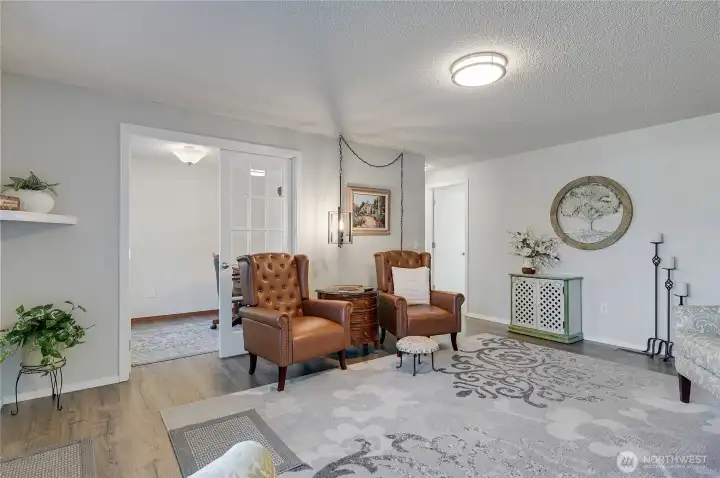 The French door from the living room goes to the office.