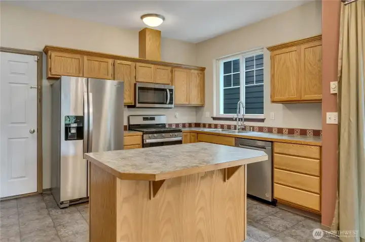 What's cooking? Lots of workspace, island for entertaining, and a pantry for storage.