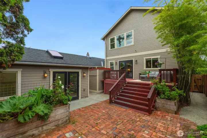 Brick patio with view towards studio/shop space