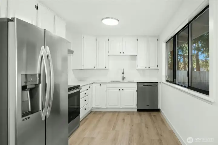 updated kitchen with new counters, lvp flooring and 1 year old appliances