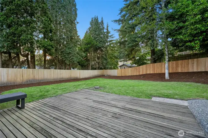 large deck with fully fenced yard