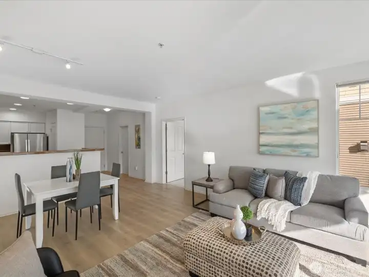 Living and dining area with open layout, connecting kitchen, seating area, and adjacent rooms for functional interior flow. Living and dining area with open layout, connecting kitchen, seating area, and adjacent rooms for functional interior flow.