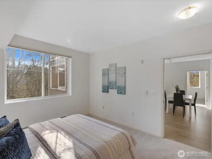Bedroom with large window overlooking wooded surroundings and direct connection to main living areas. Layout supports separation between bedrooms and shared spaces. Bedroom with large window overlooking wooded surroundings and direct connection to main living areas. Layout supports separation between bedrooms and shared spaces.