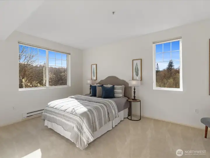 Bedroom with multiple windows providing natural light and views of surrounding greenery. Freshly cleaned carpets. Bedroom with multiple windows providing natural light and views of surrounding greenery. Freshly cleaned carpets.