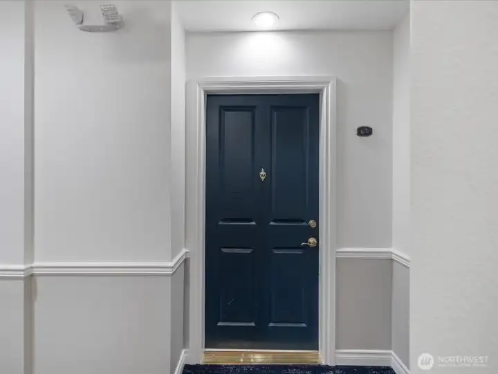 Interior entry with secure building access, controlled lobby entry, and defined hallway leading into unit living spaces. Interior entry with secure building access, controlled lobby entry, and defined hallway leading into unit living spaces.