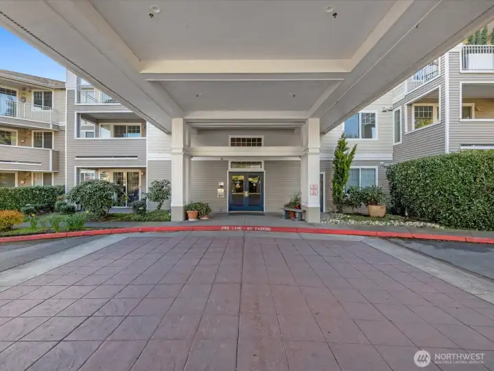 Covered building entrance with drive-up access for loading and unloading, located at the main lobby entry. Covered building entrance with drive-up access for loading and unloading, located at the main lobby entry.