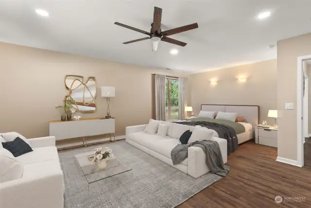 The extra-large primary bedroom includes an en-suite bathroom and a cozy sitting area, perfect for enjoying your morning coffee or winding down wih good book at the end of the day. Staging is virtual.
